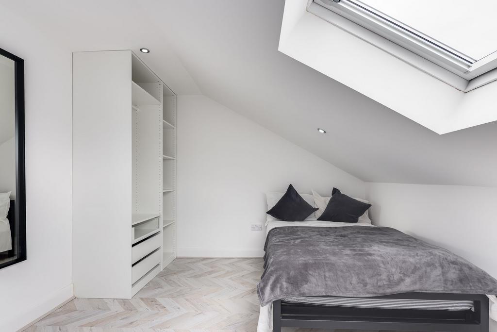 Bright and minimalistic bedroom featuring a dou...