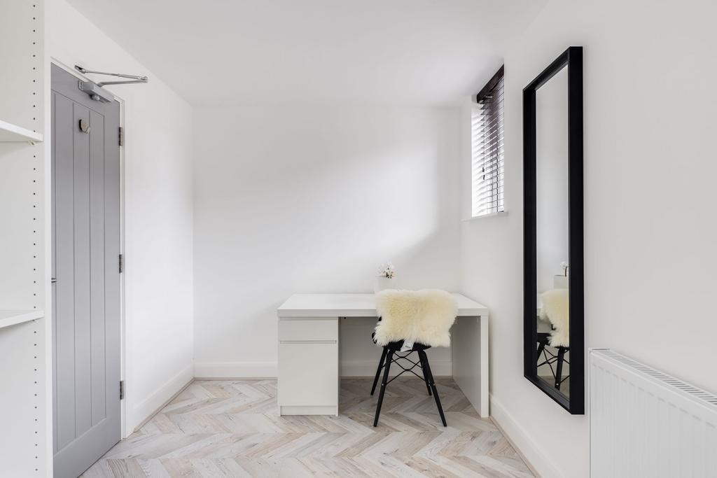 Bright and neatly maintained bedroom featuring ...