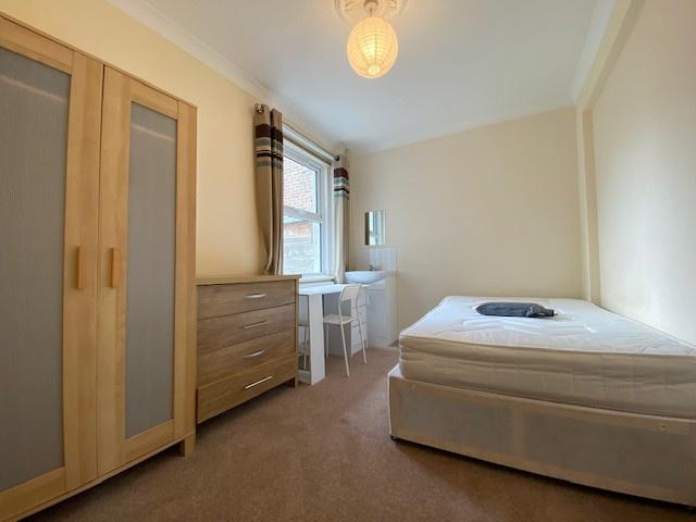A bright and tidy double bedroom featuring a co...