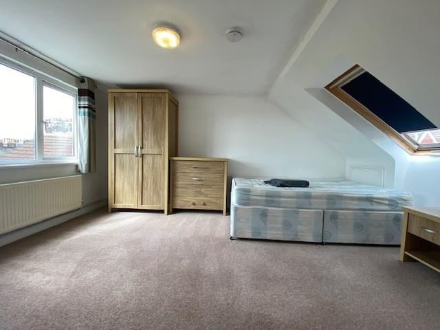 A spacious and well-maintained living room feat...