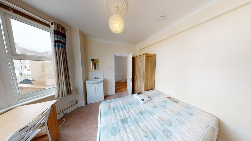 Bright and welcoming double bedroom featuring a...