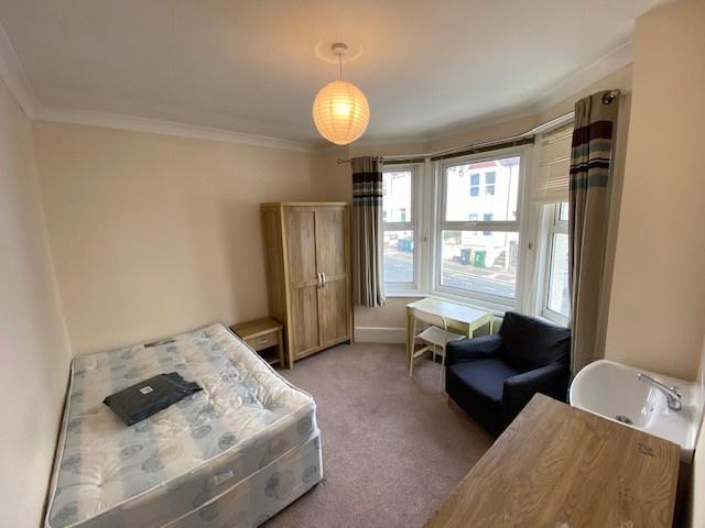 A cozy, well-lit bedroom featuring a double bed...