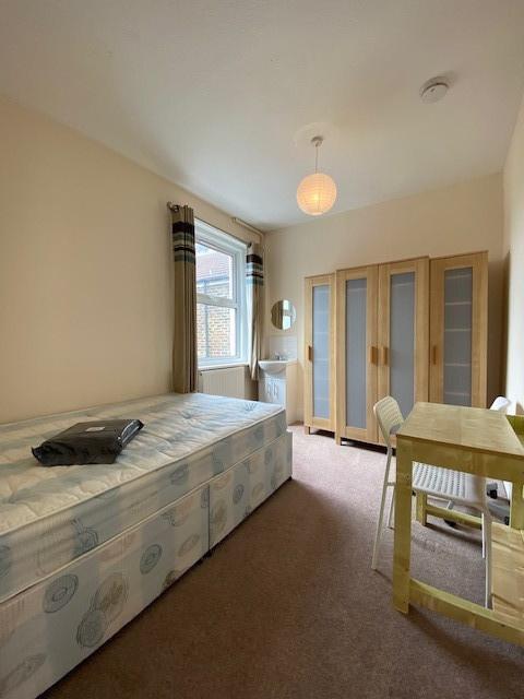 A bright and welcoming double bedroom featuring...