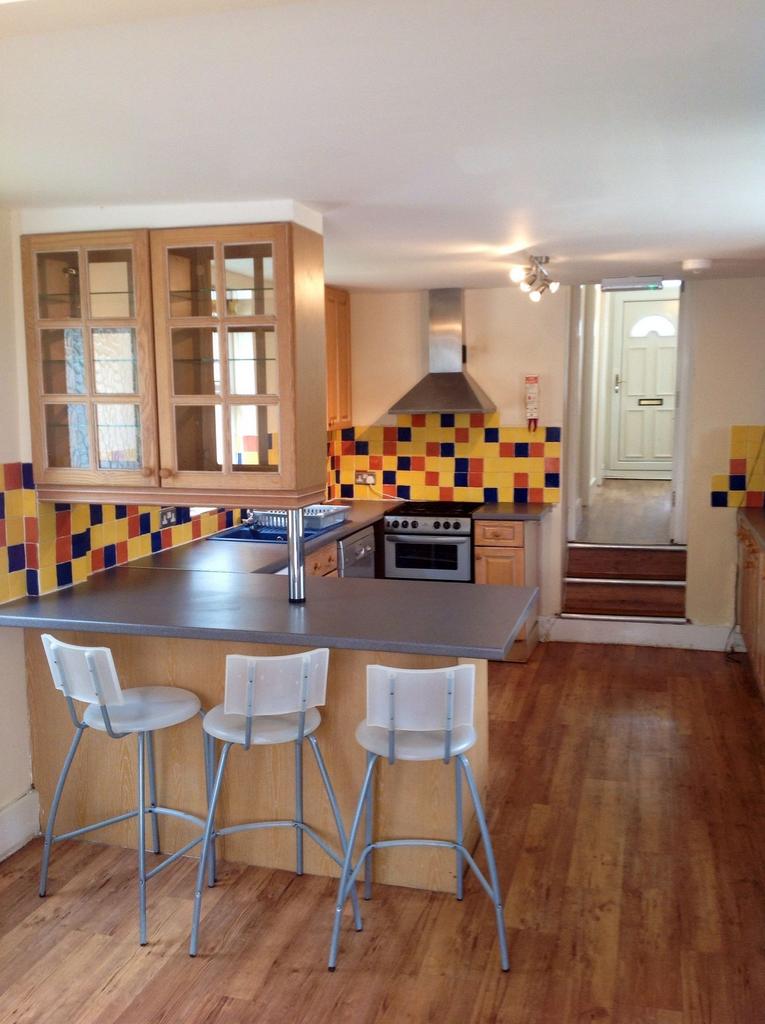 A bright, modern kitchen featuring a colorful t...