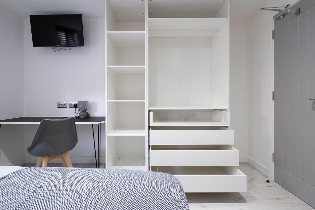 A clean and modern single toilet room featuring...