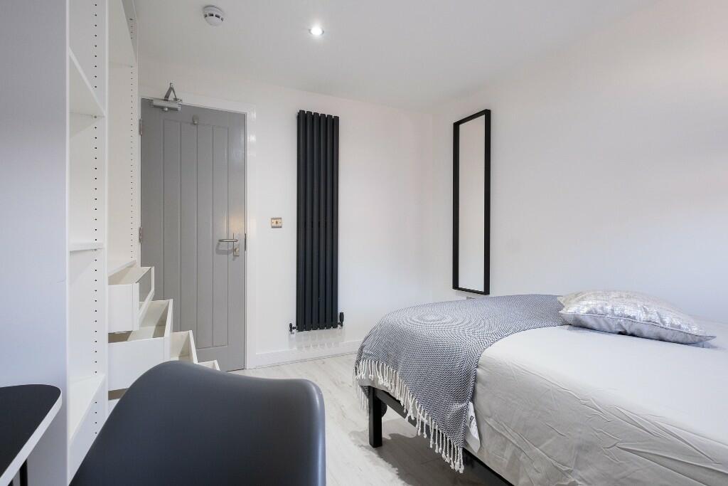 Bright and tidy single bedroom featuring a neat...