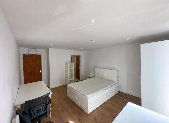 Bright and spacious master bedroom featuring a ...