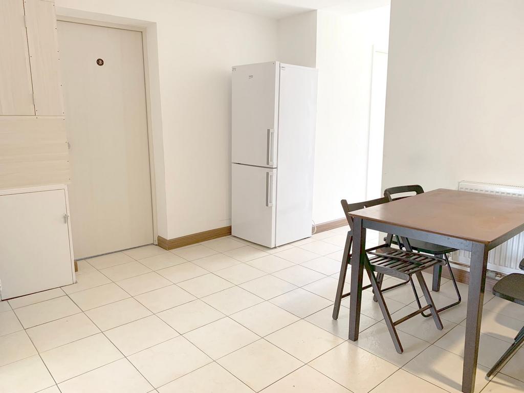 A bright and clean kitchen space featuring a wh...
