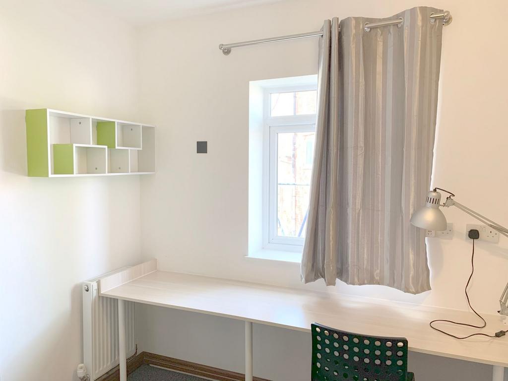 A bright and tidy communal workspace featuring ...