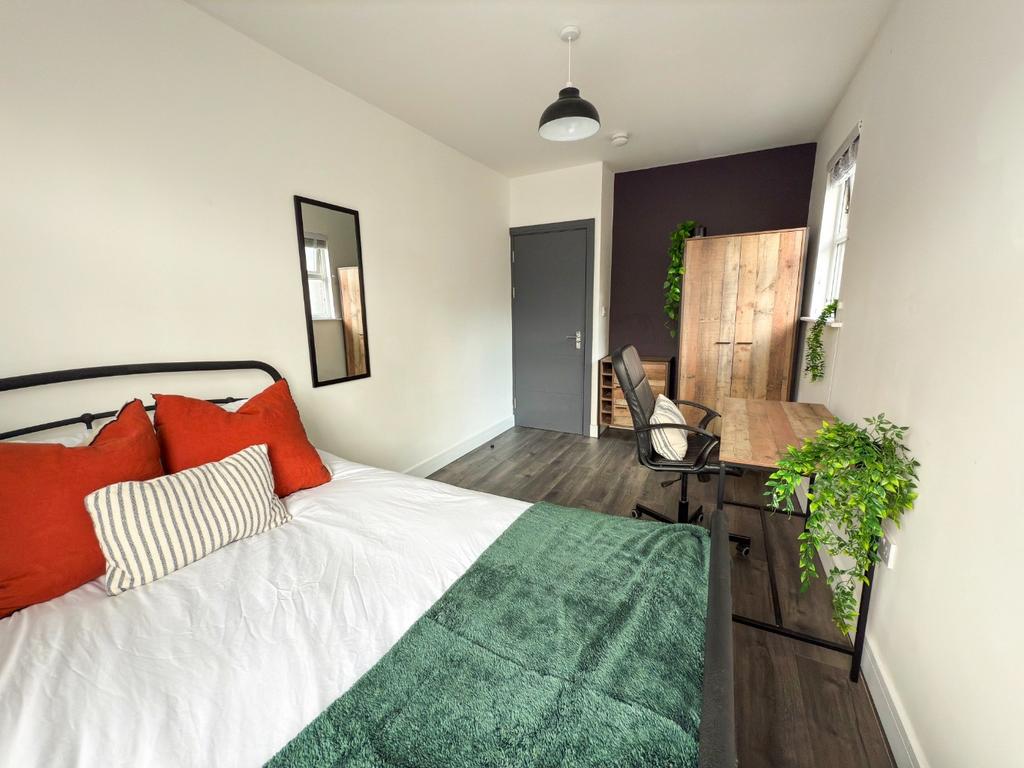 Bright and spacious master bedroom featuring a ...