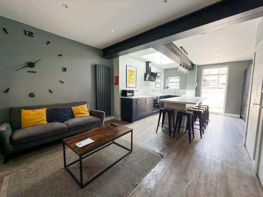 A modern, well-lit living room featuring a comf...