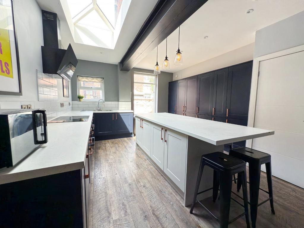 A modern and well-lit kitchen with ample counte...