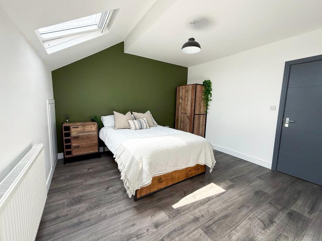 A bright, neatly maintained bedroom featuring a...