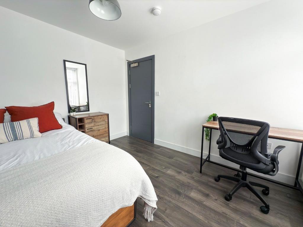 A well-maintained bedroom featuring a comfortab...