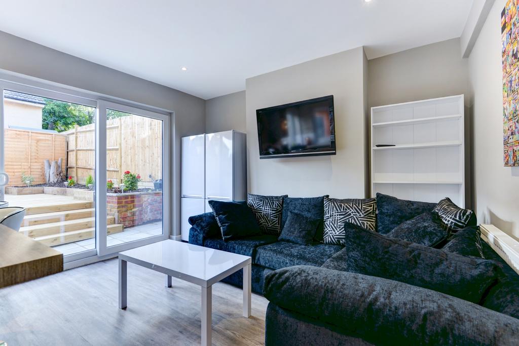 A bright and cozy living room featuring a large...