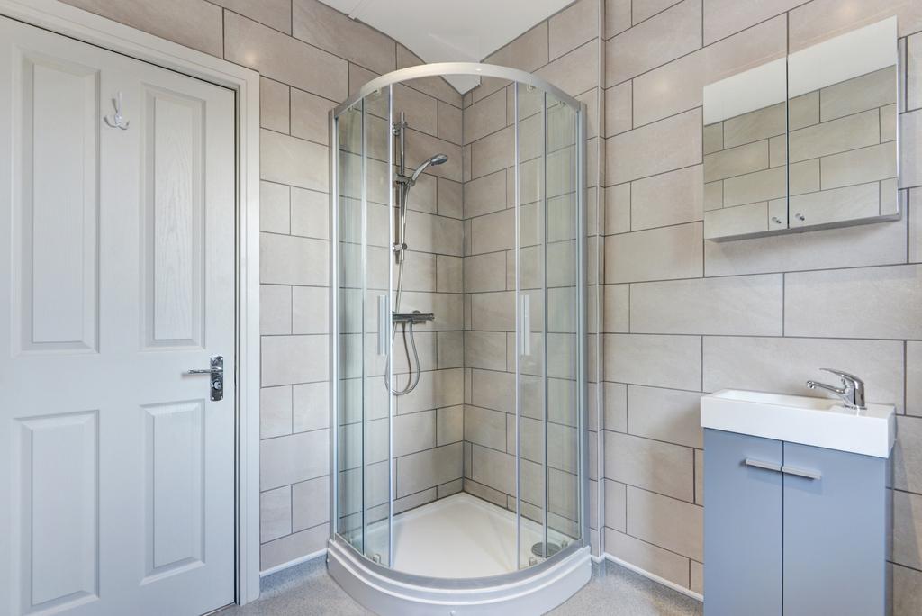 A spacious, modern bathroom featuring a large s...