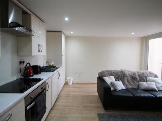 A modern, well-lit living room with large windo...