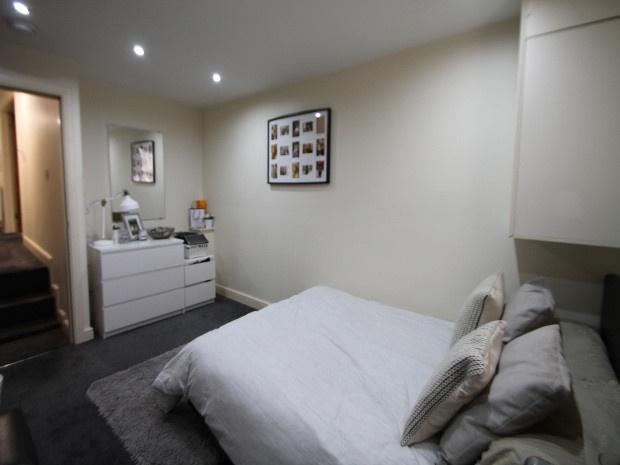 A spacious, well-maintained master bedroom feat...