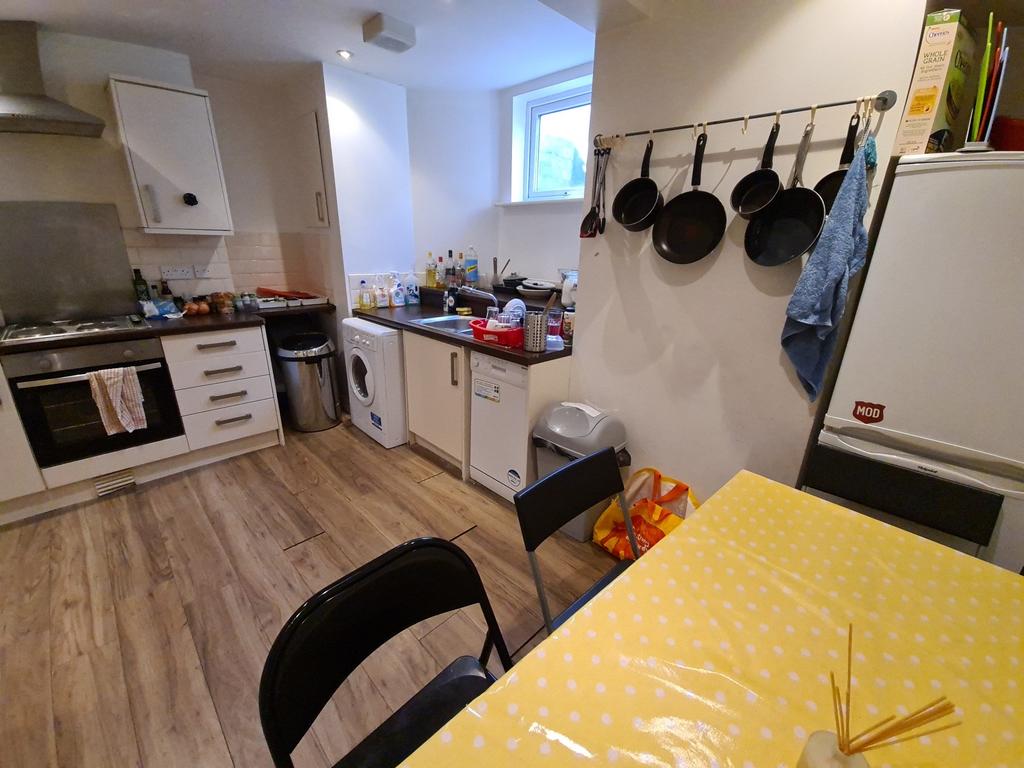Modern kitchen area with a yellow dining table,...