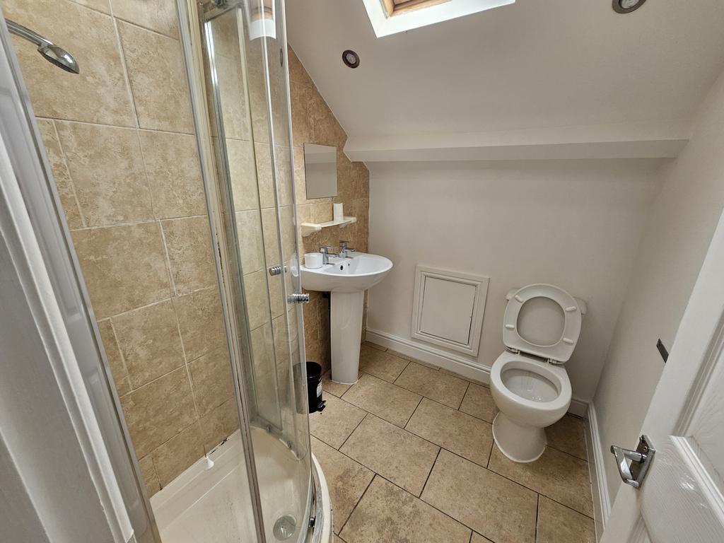 A clean and functional bathroom with a shower e...