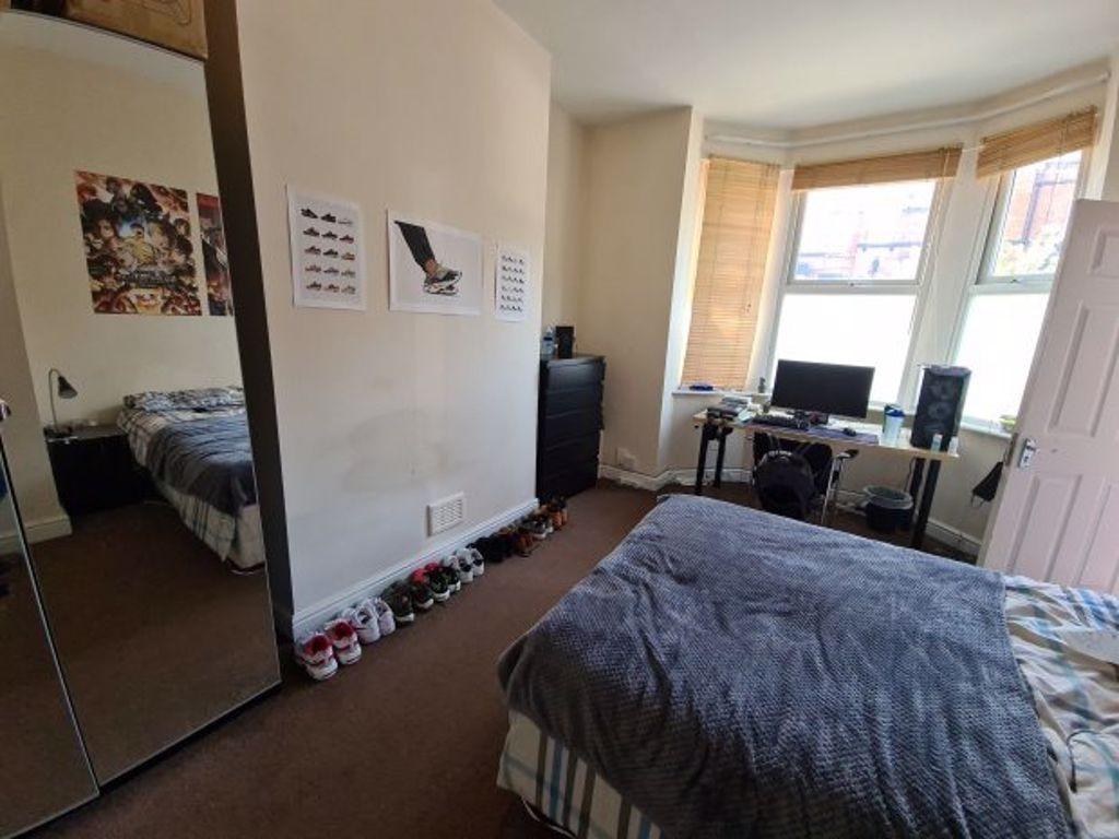 A well-lit bedroom featuring a double bed, ampl...