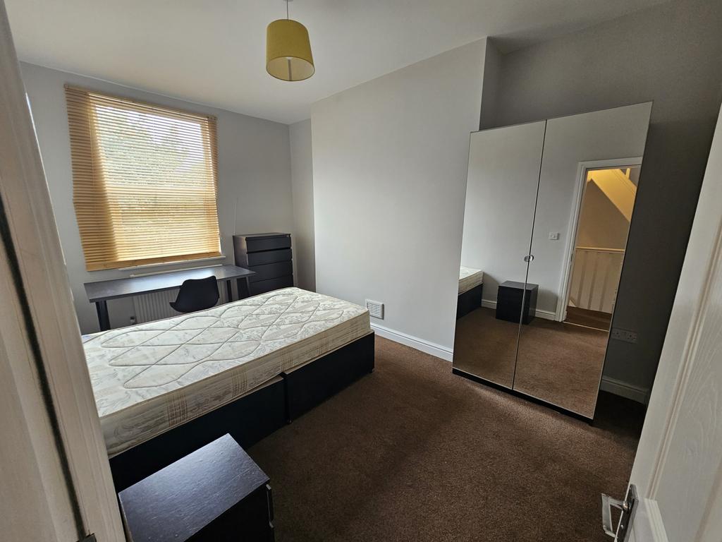 A bright and well-maintained master bedroom fea...