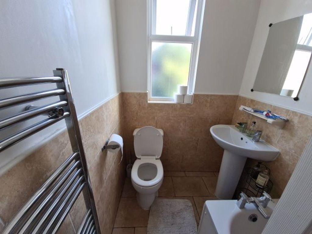Bright and tidy bathroom with a WC, sink, and wi...