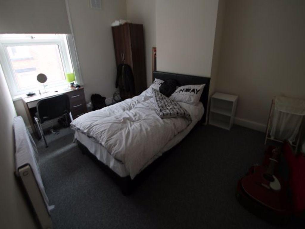 A cozy and well-maintained bedroom featuring a ...