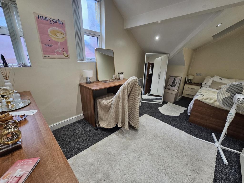 A cozy, well-lit bedroom featuring a double bed...