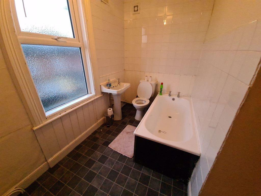 A bright and inviting bathroom with a large bat...