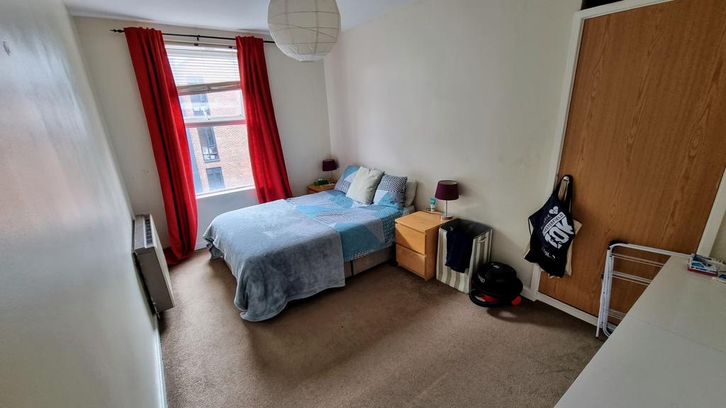Cozy single bedroom featuring a comfortable bed...
