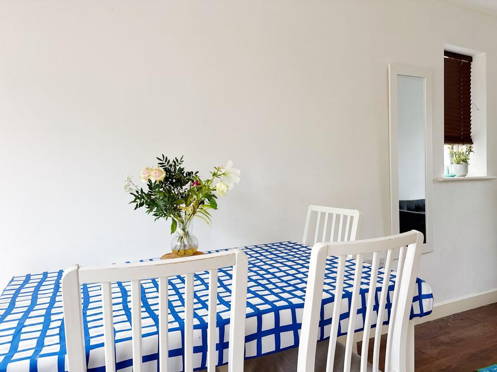 Bright, minimalist dining area with a patterned...