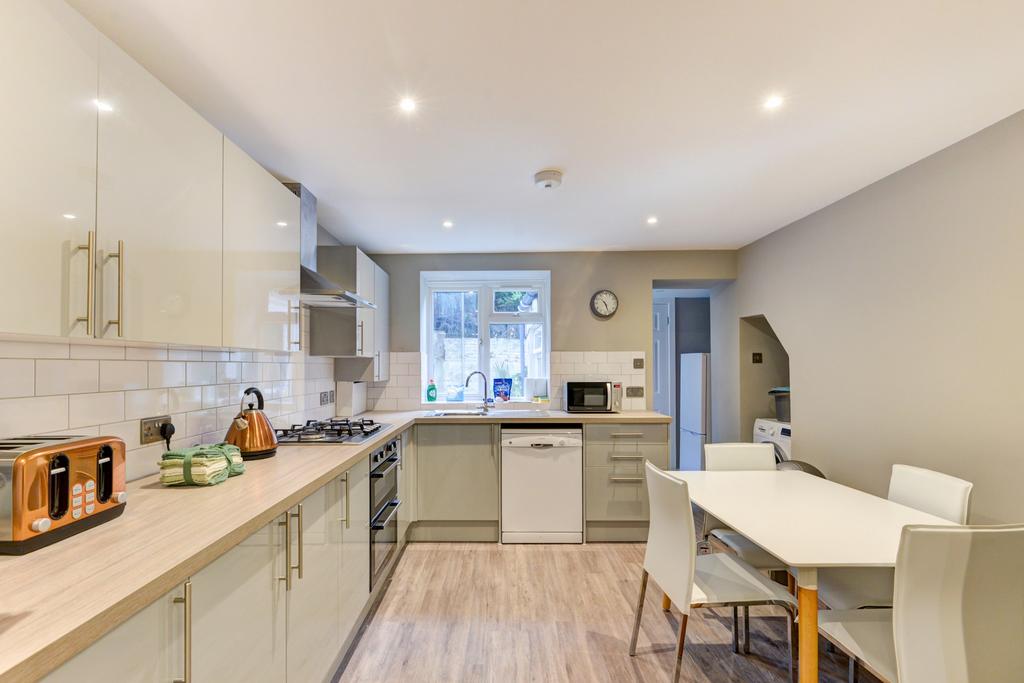 A bright and modern kitchen featuring ample cou...
