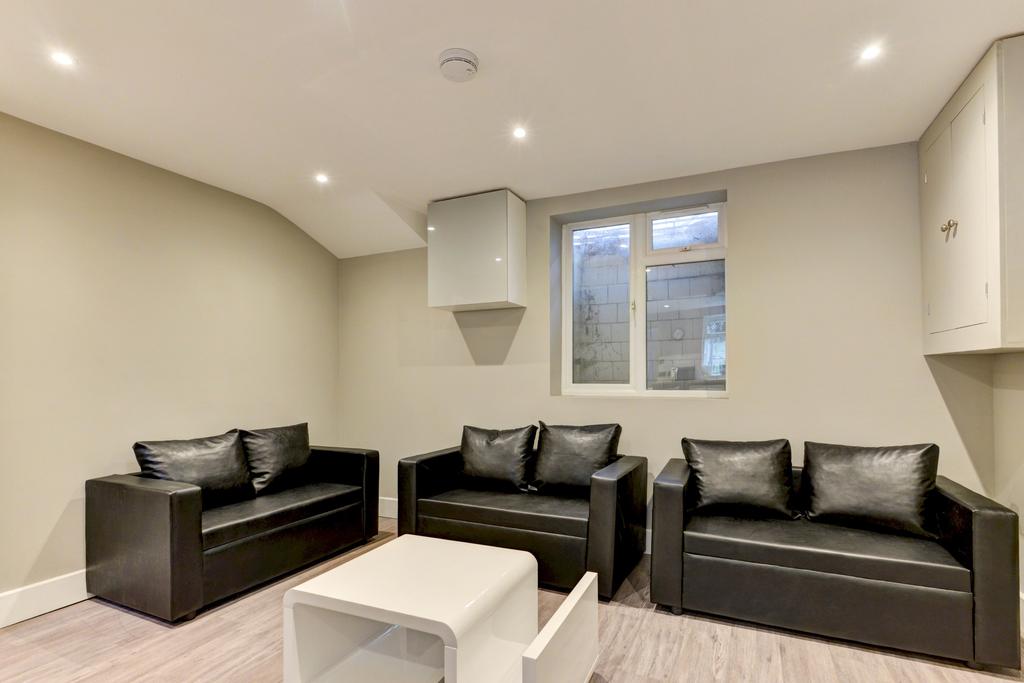 A modern, well-lit living room featuring three ...