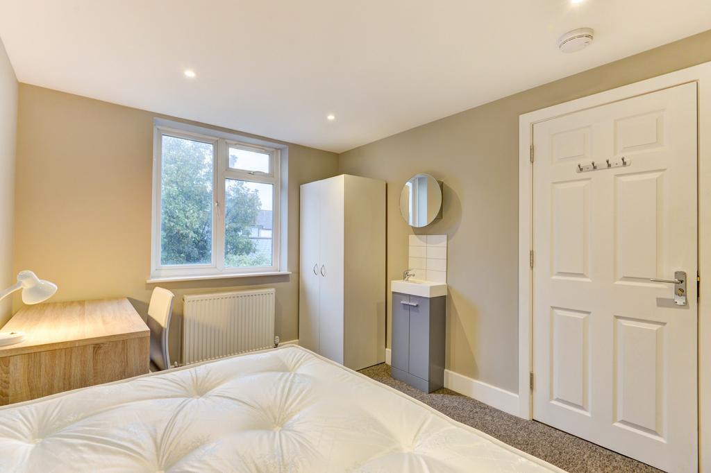 A bright and inviting bedroom with ample natura...