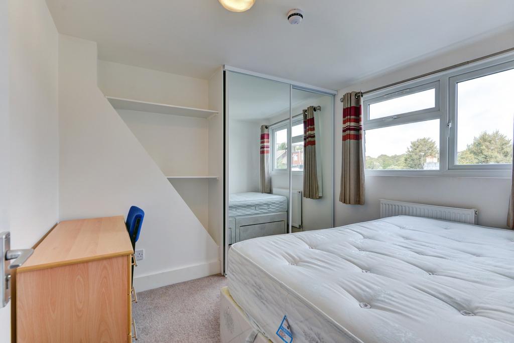 Bright, neatly presented bedroom with a comfort...
