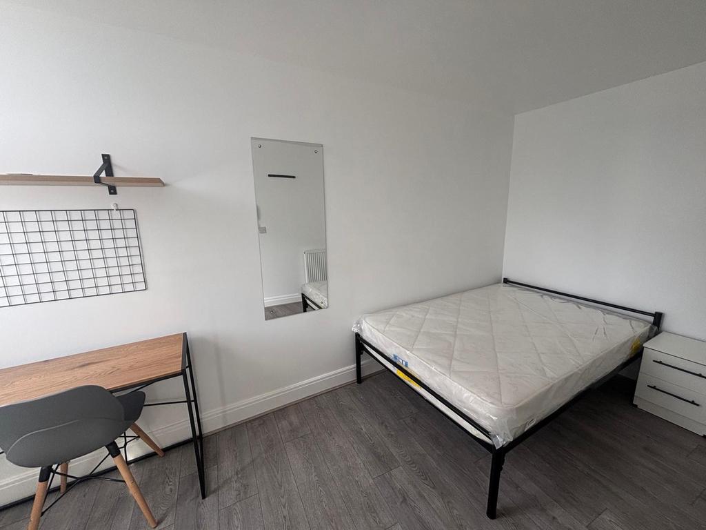 A bright and inviting double bedroom featuring ...
