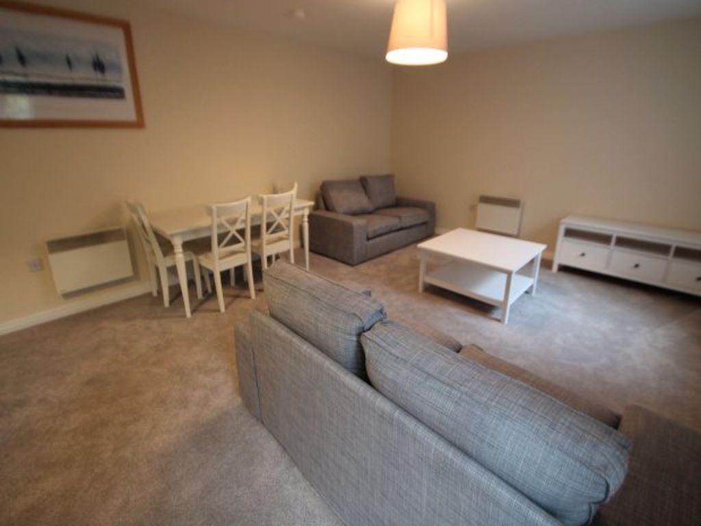 Bright, neutral living room with matching grey ...