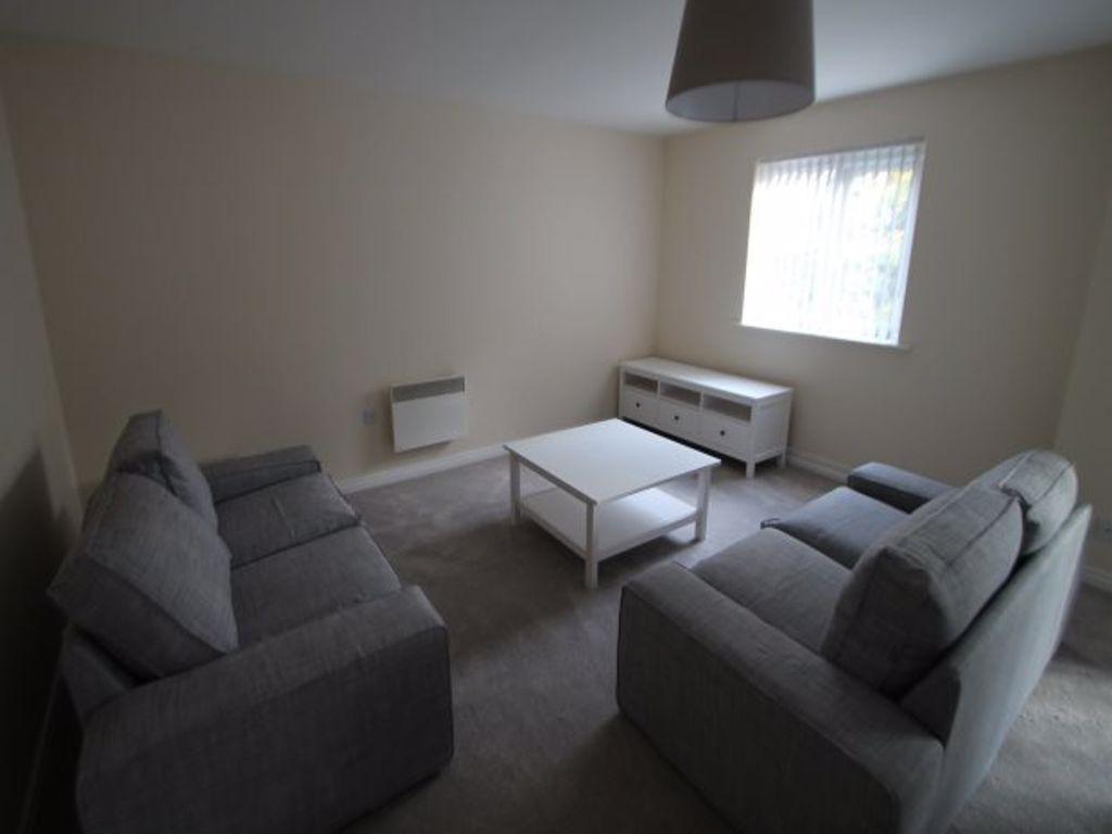 Bright, neutrally decorated living room with ma...