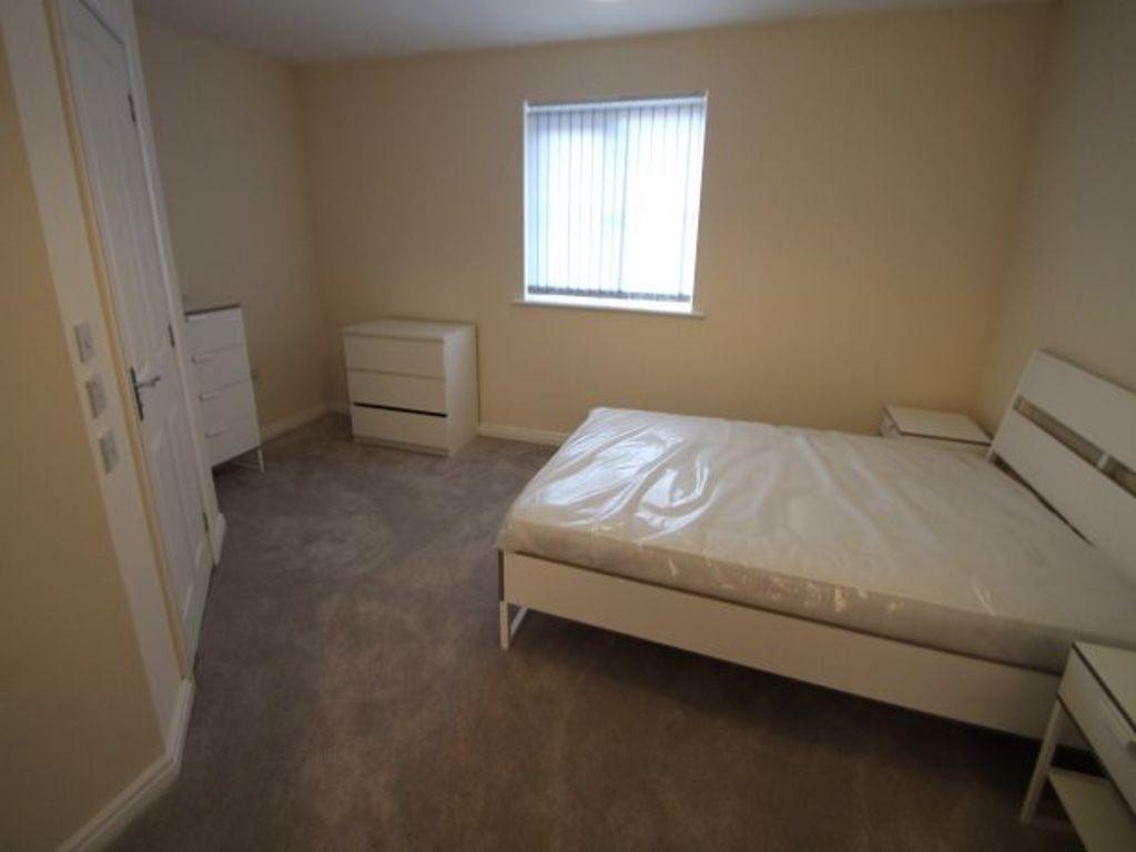 Bright, neutrally decorated double bedroom with...