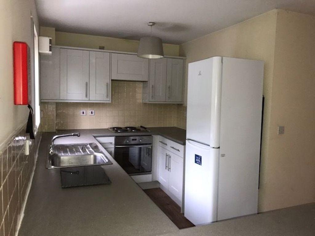 Bright, modern fitted kitchen with ample counte...