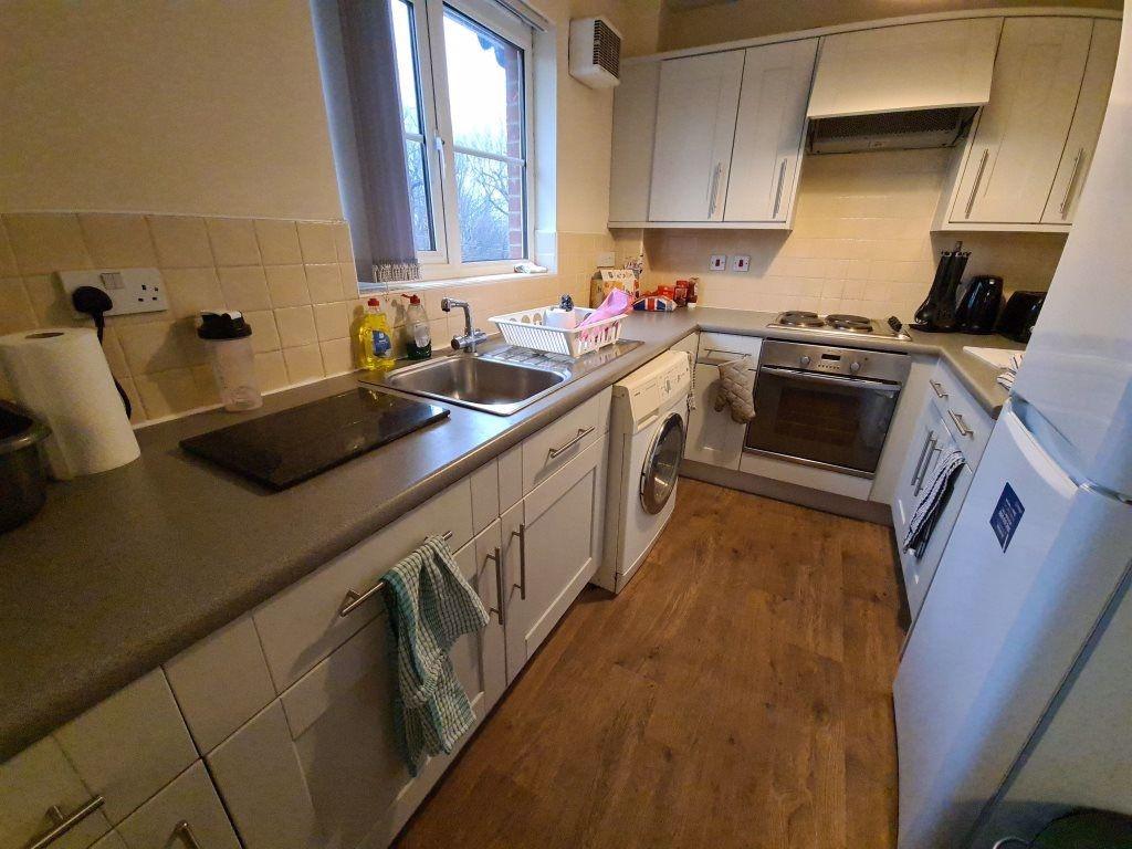 Neat fitted kitchen with ample counter space, i...
