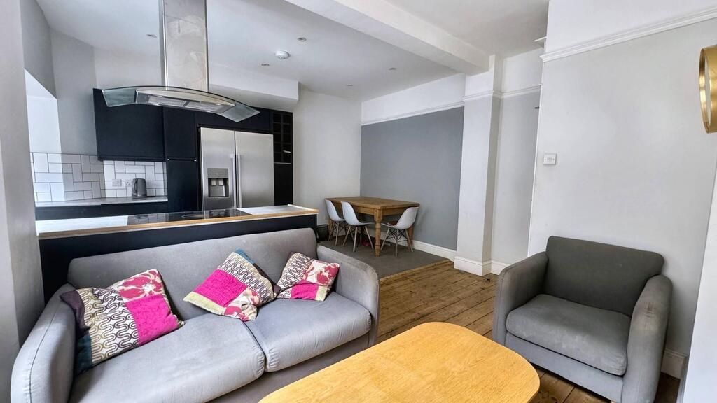 Contemporary open-plan living area with a comfo...