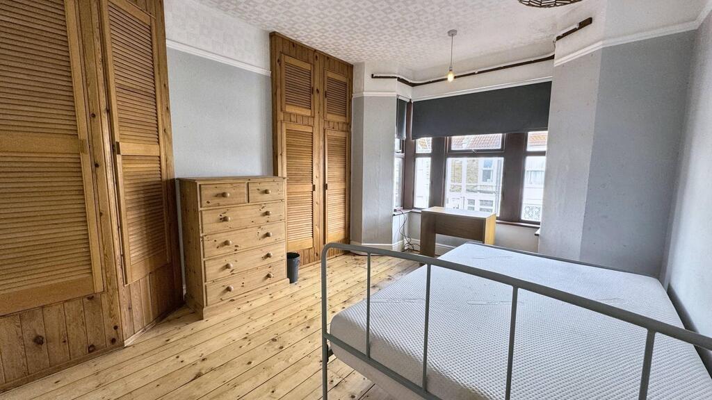 Bright double bedroom with wooden floors, built...