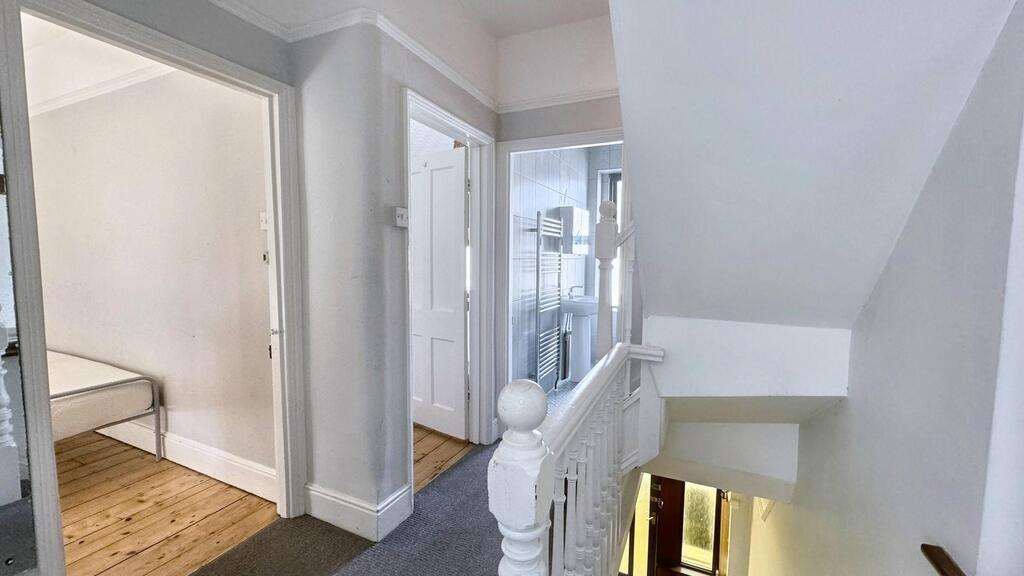 Bright, freshly painted hallway with white balu...