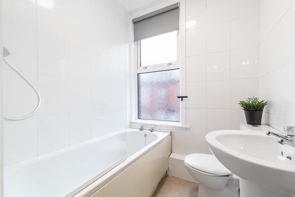 Bright, modern bathroom with a full bathtub, wh...