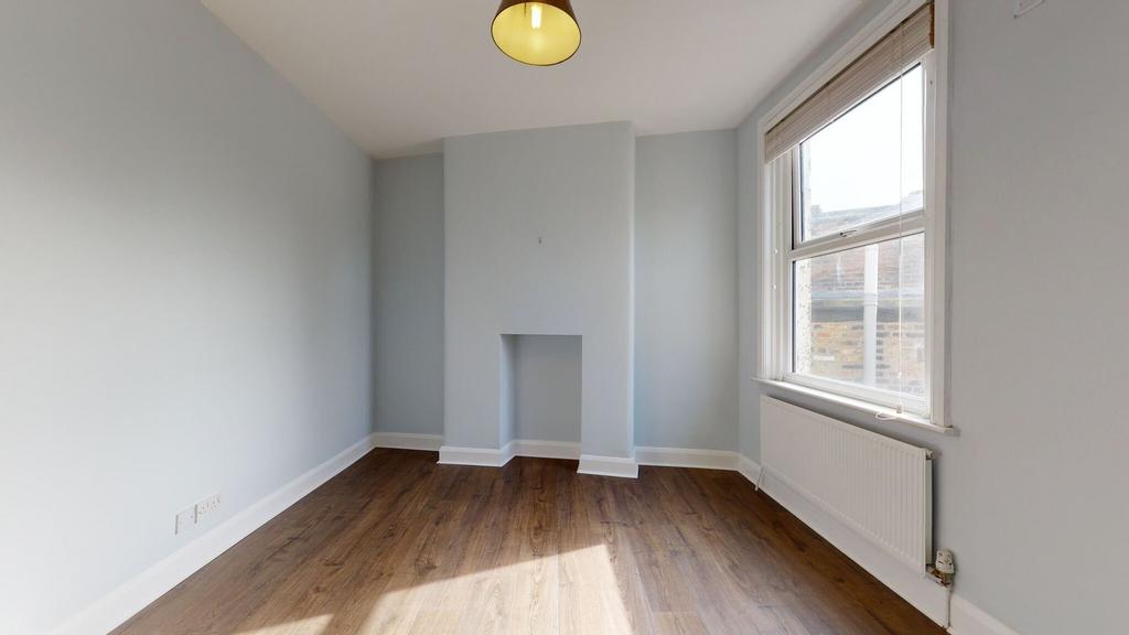 A bright and freshly painted single bedroom fea...
