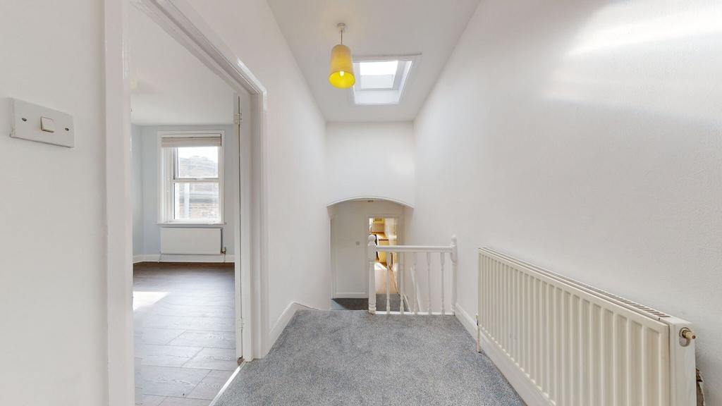 A bright and clean upstairs hallway featuring w...