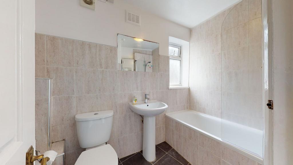 Bright and well-maintained bathroom featuring a...