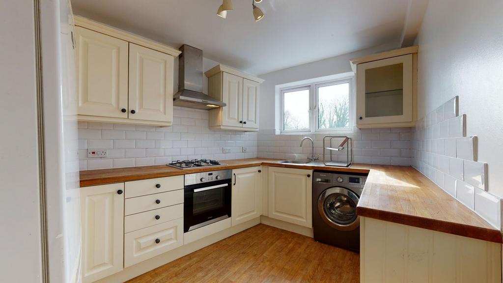 Bright and clean kitchen featuring wooden count...